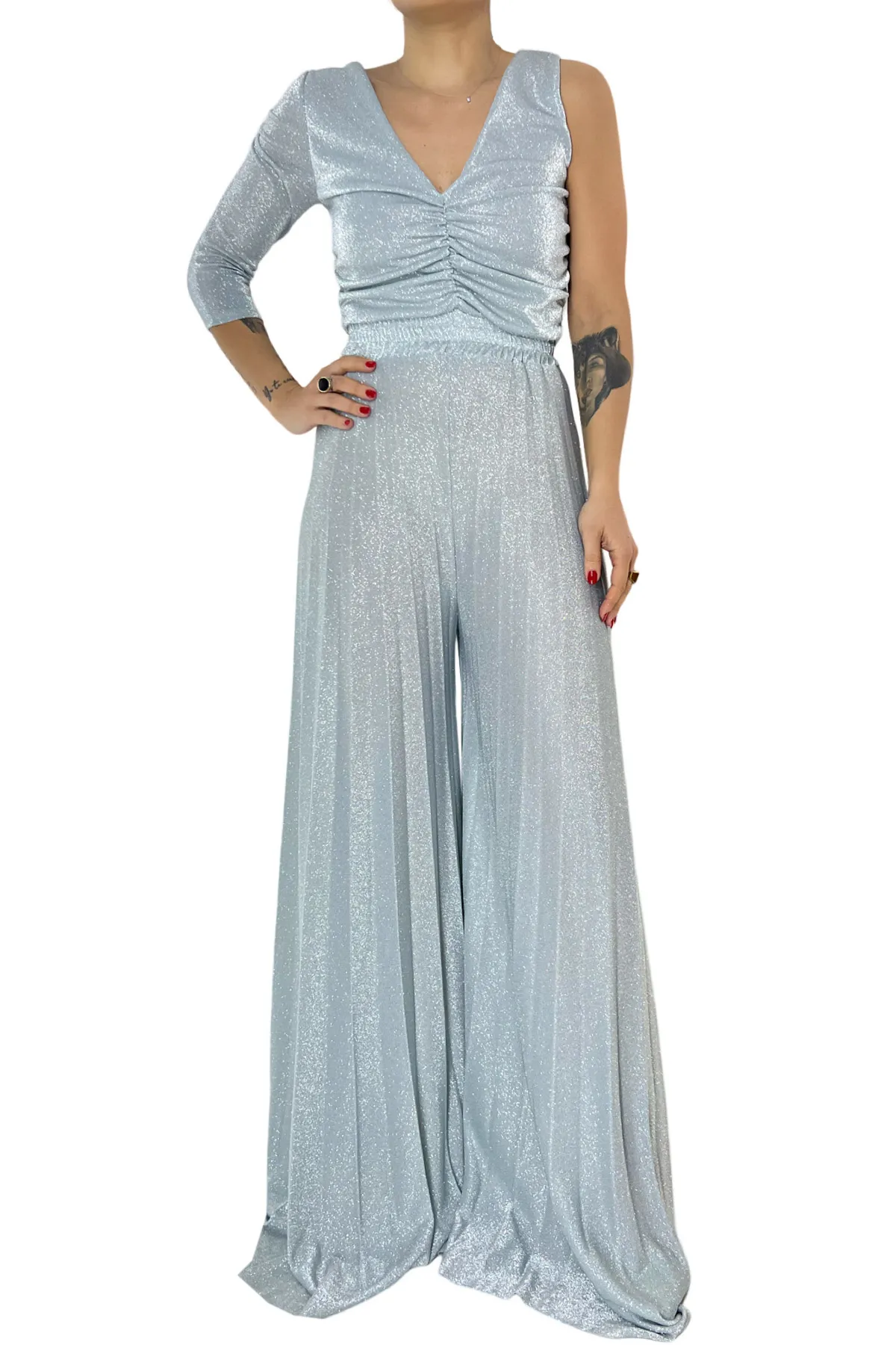 Tuta donna in jersey lurex monospalla fascia elastica che segna il punto vita e pantalone plissettato